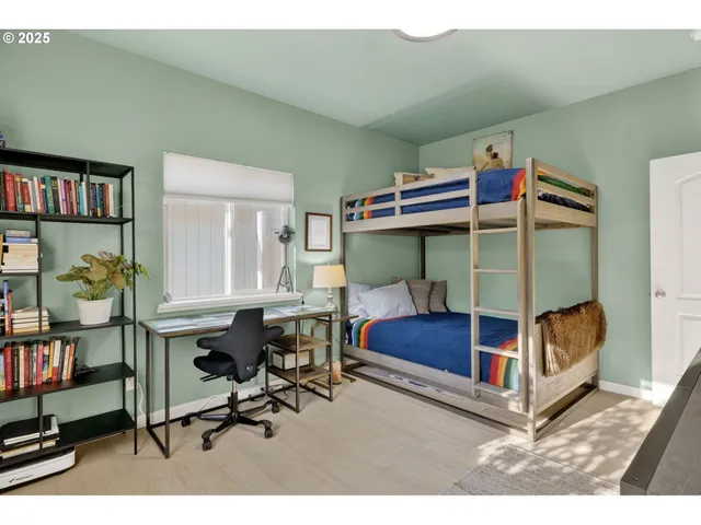 a bedroom with a bunk bed and a desk in it