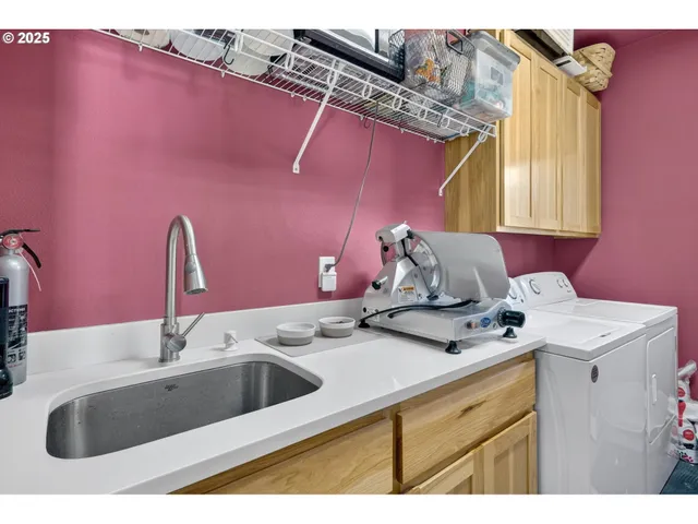 a kitchen with a sink cabinets and wooden floor