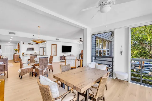 a living room with furniture a flat screen tv and a window