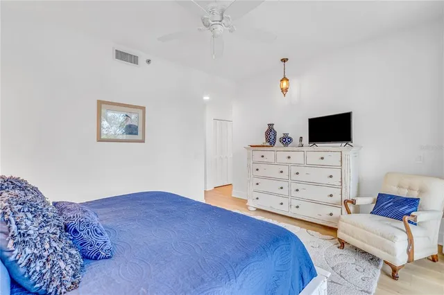 a bedroom with a bed and a television