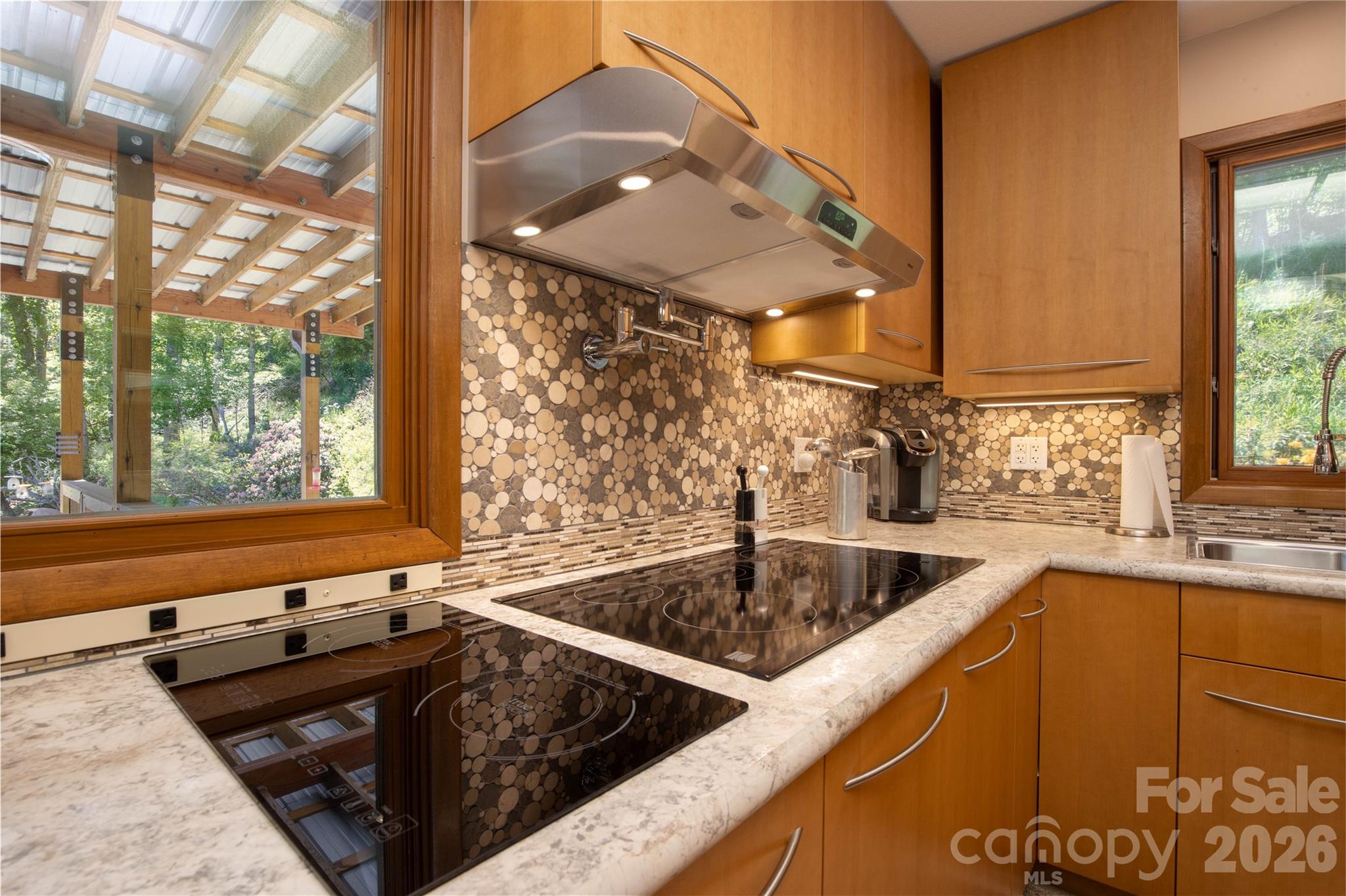 93 Franklin Crest Road Spruce Pine, NC 28777 - Photo 29 of 47 a kitchen with a sink stove and cabinets