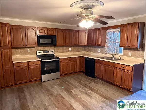 a kitchen with stainless steel appliances granite countertop a sink dishwasher stove and refrigerator