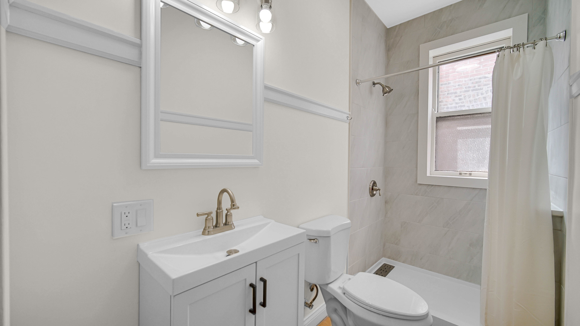 1213 East 53rd Street, Unit 3W Chicago, IL 60615 - Photo 13 of 21 a bathroom with a sink a toilet and shower
