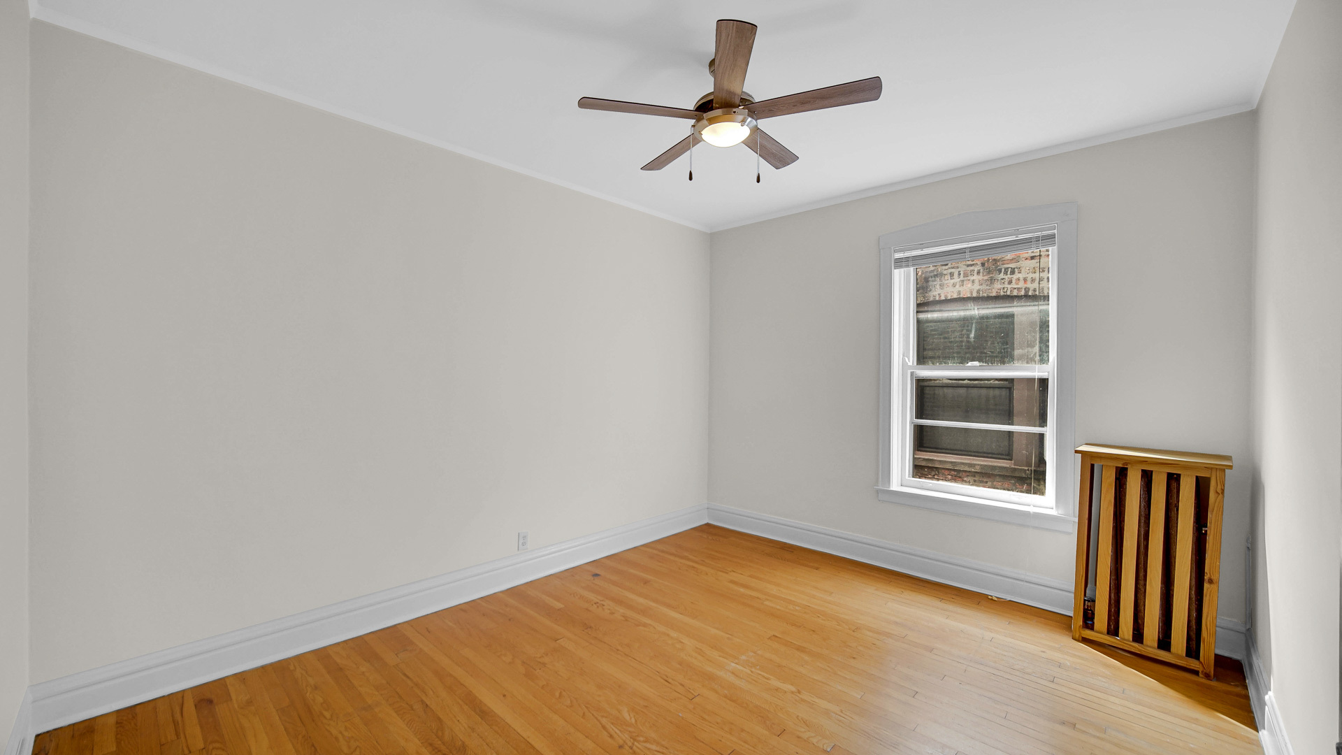 1213 East 53rd Street, Unit 3W Chicago, IL 60615 - Photo 16 of 21 an empty room with a window and ceiling fan