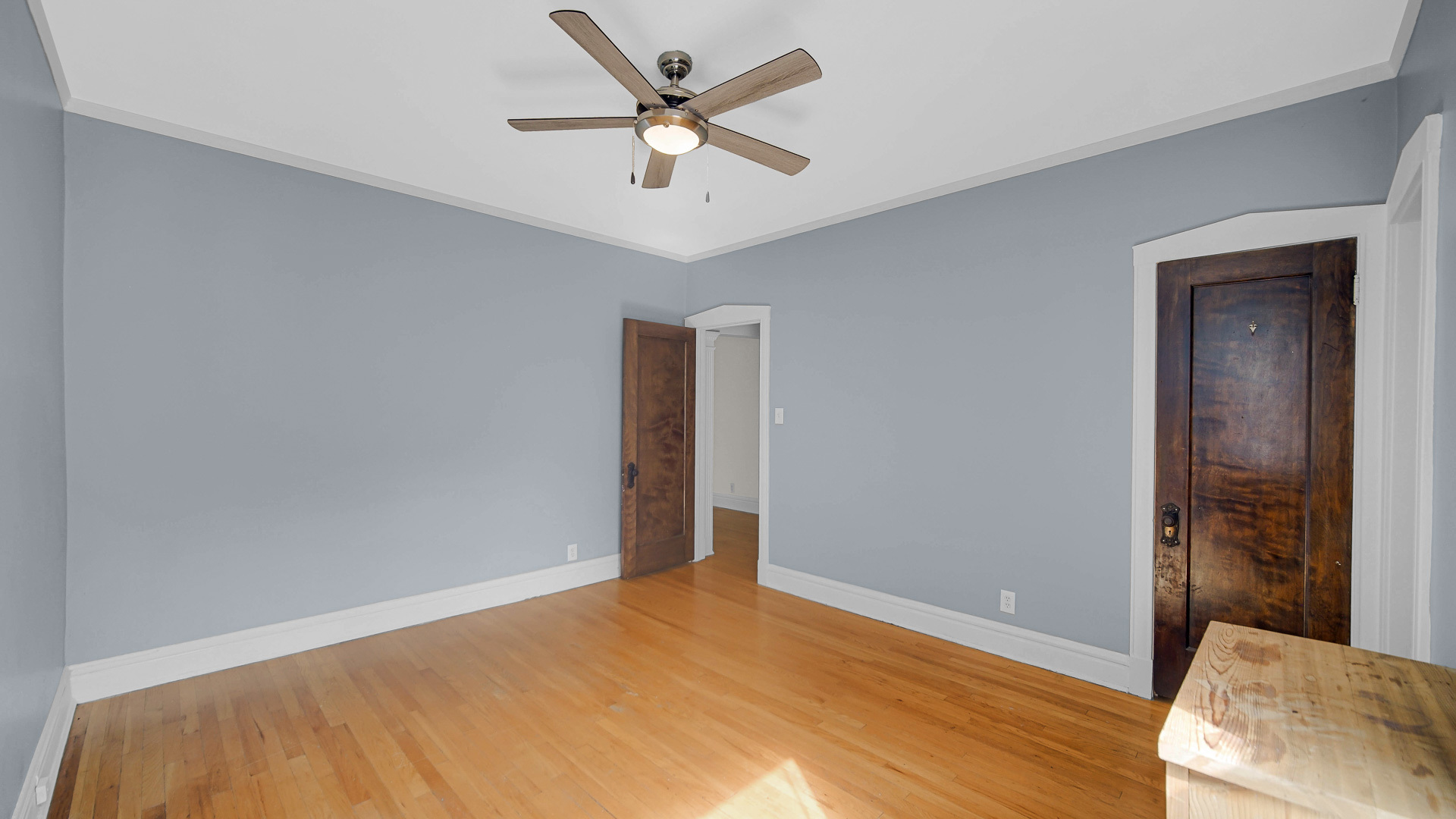 1213 East 53rd Street, Unit 3W Chicago, IL 60615 - Photo 17 of 21 a view of a big room with wooden floor and a chandelier fan