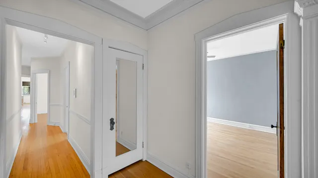 a view of a hallway with wooden floor