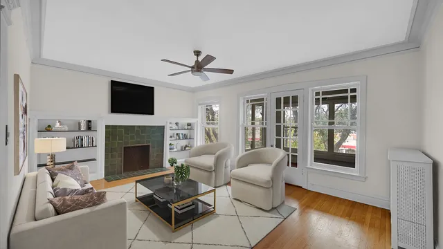 a living room with furniture a fireplace and a flat screen tv
