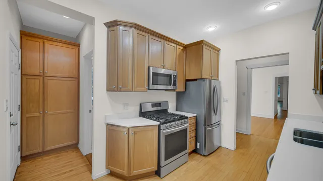 a kitchen with stainless steel appliances granite countertop a refrigerator and a stove top oven