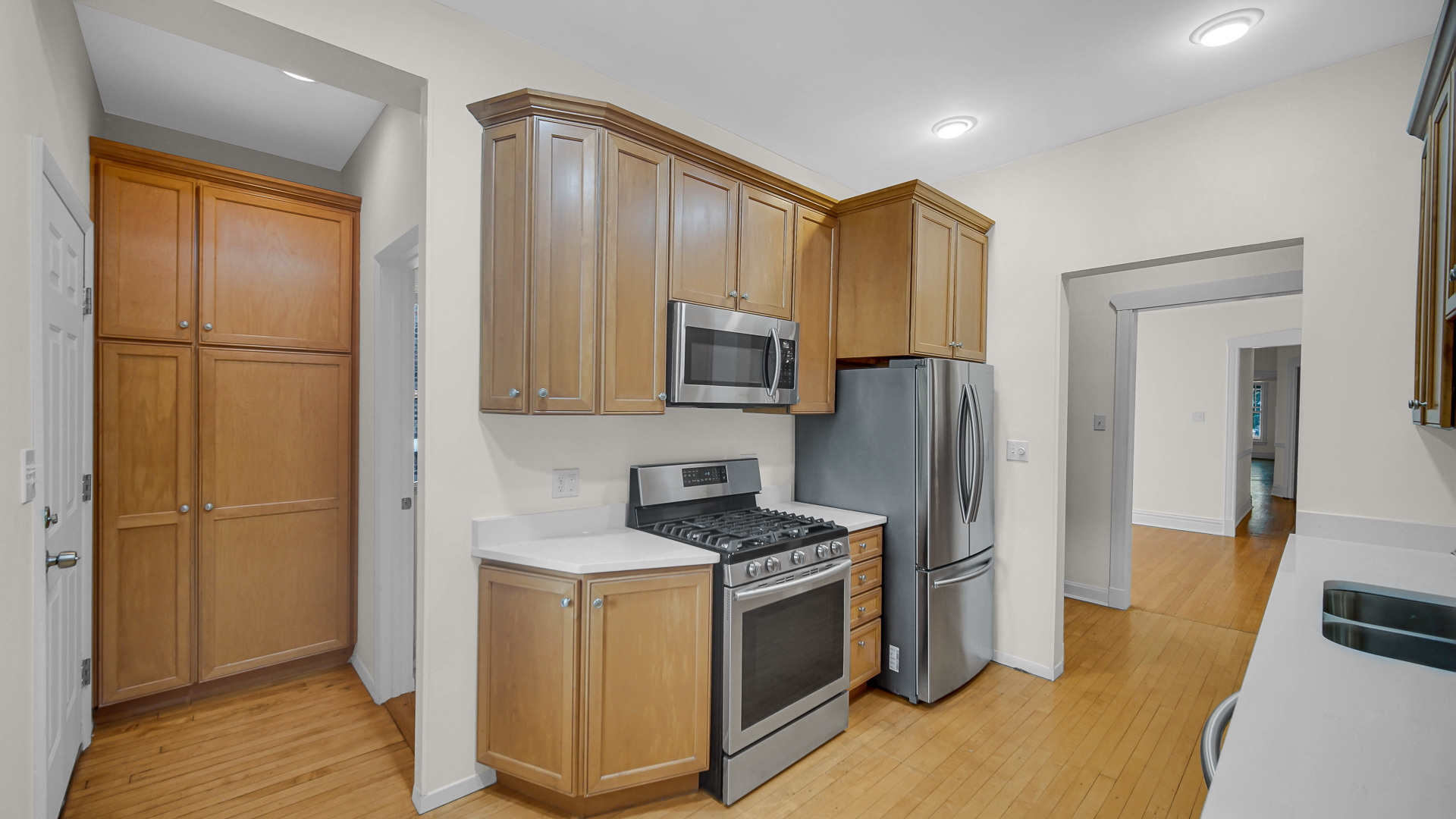 1213 East 53rd Street, Unit 3W Chicago, IL 60615 - Photo 6 of 21 a kitchen with stainless steel appliances granite countertop a refrigerator and a stove top oven