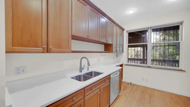 a kitchen with a sink cabinets and a window
