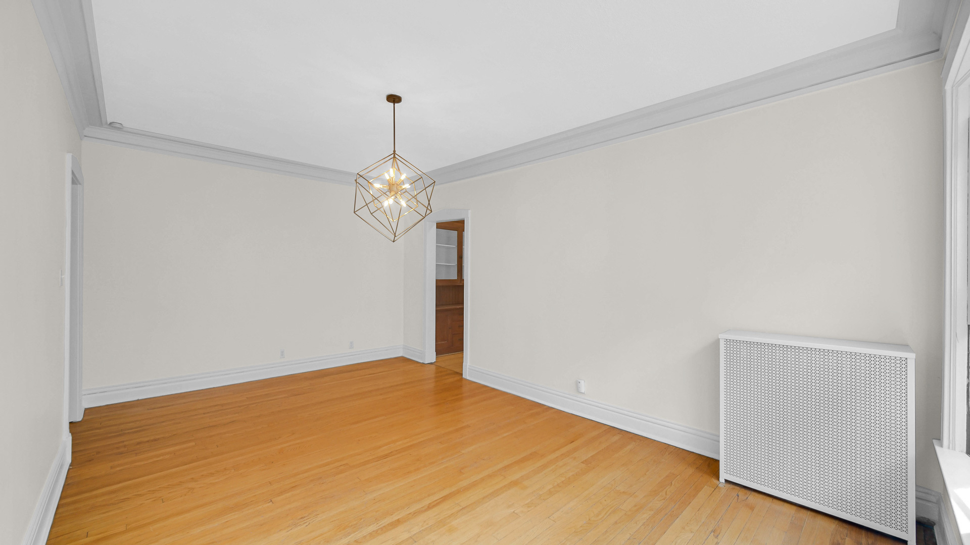 1213 East 53rd Street, Unit 3W Chicago, IL 60615 - Photo 10 of 21 a big room with chandelier fan and wooden floor