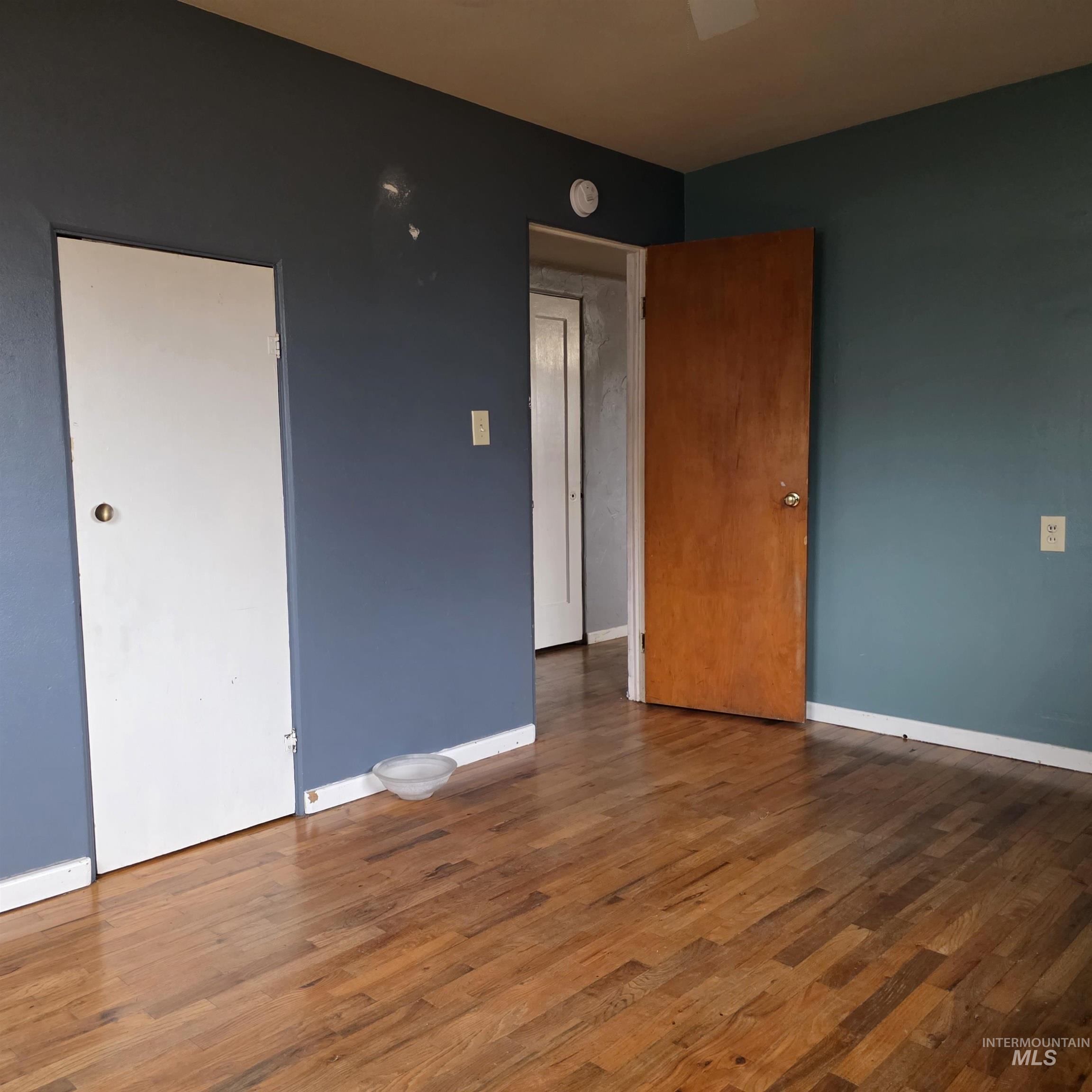 935 Preston Avenue Lewiston, ID 83501 - Photo 12 of 22 Empty room with dark wood-style floors and baseboards