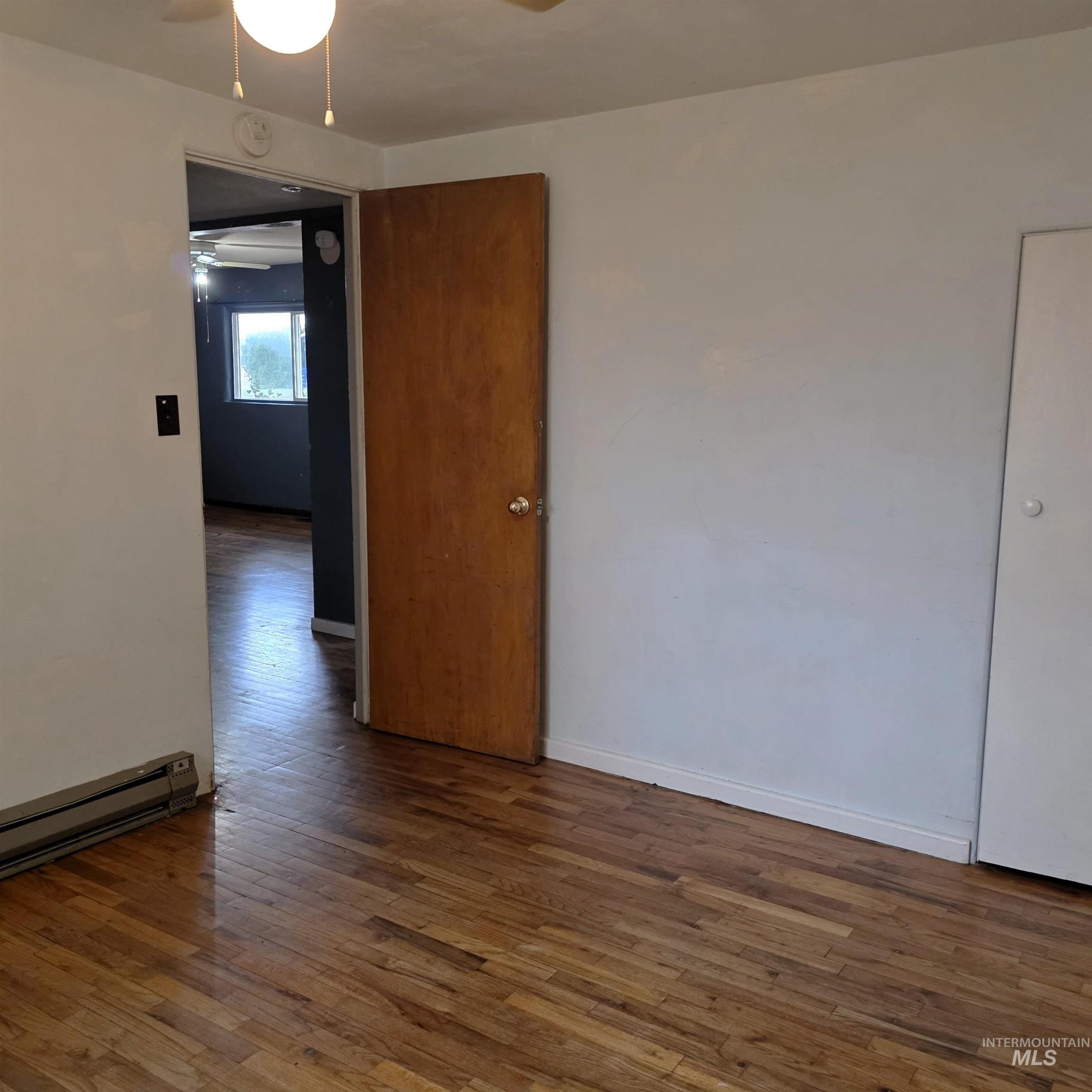 935 Preston Avenue Lewiston, ID 83501 - Photo 18 of 22 Unfurnished room featuring wood-type flooring and ceiling fan