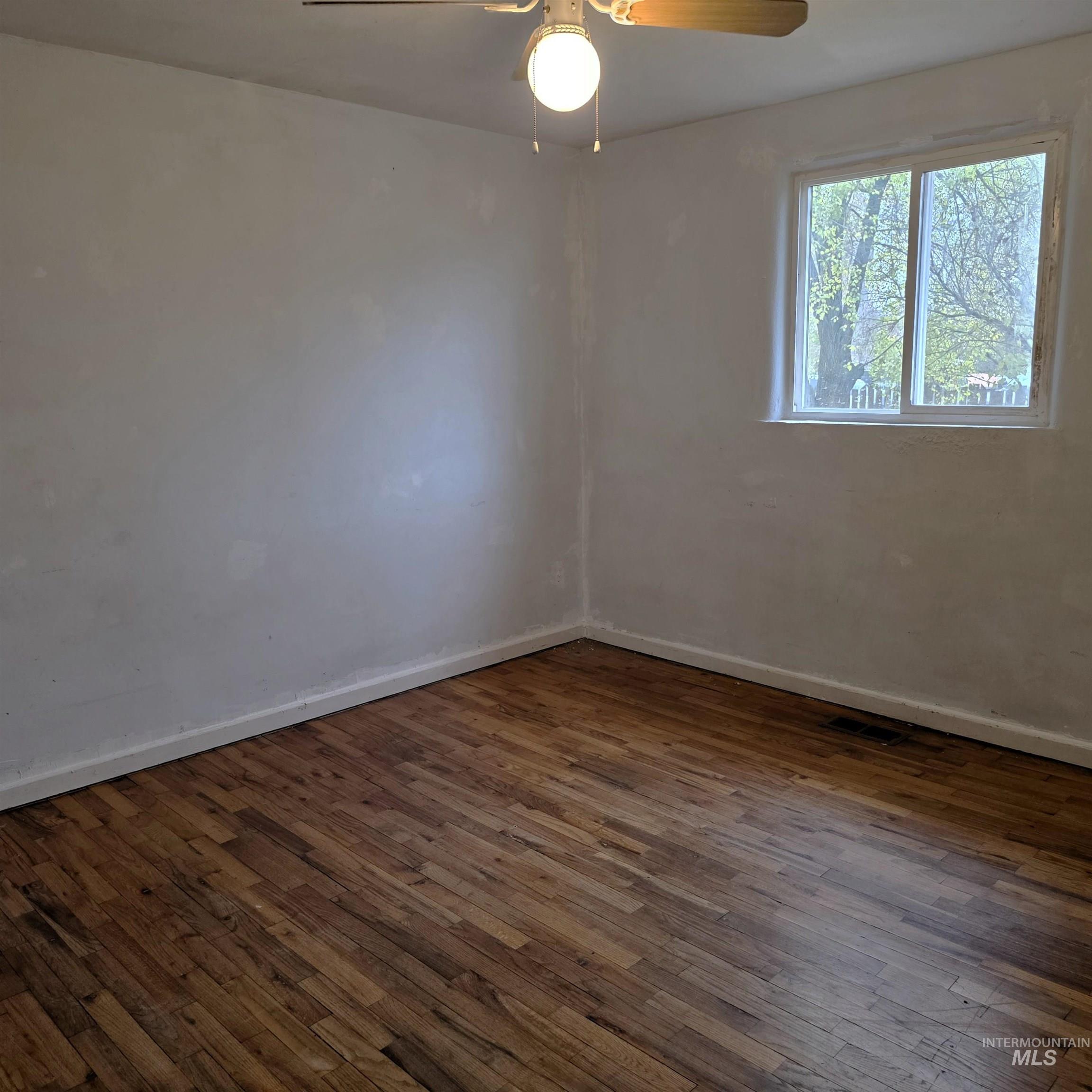 935 Preston Avenue Lewiston, ID 83501 - Photo 19 of 22 Unfurnished room featuring dark wood finished floors and ceiling fan