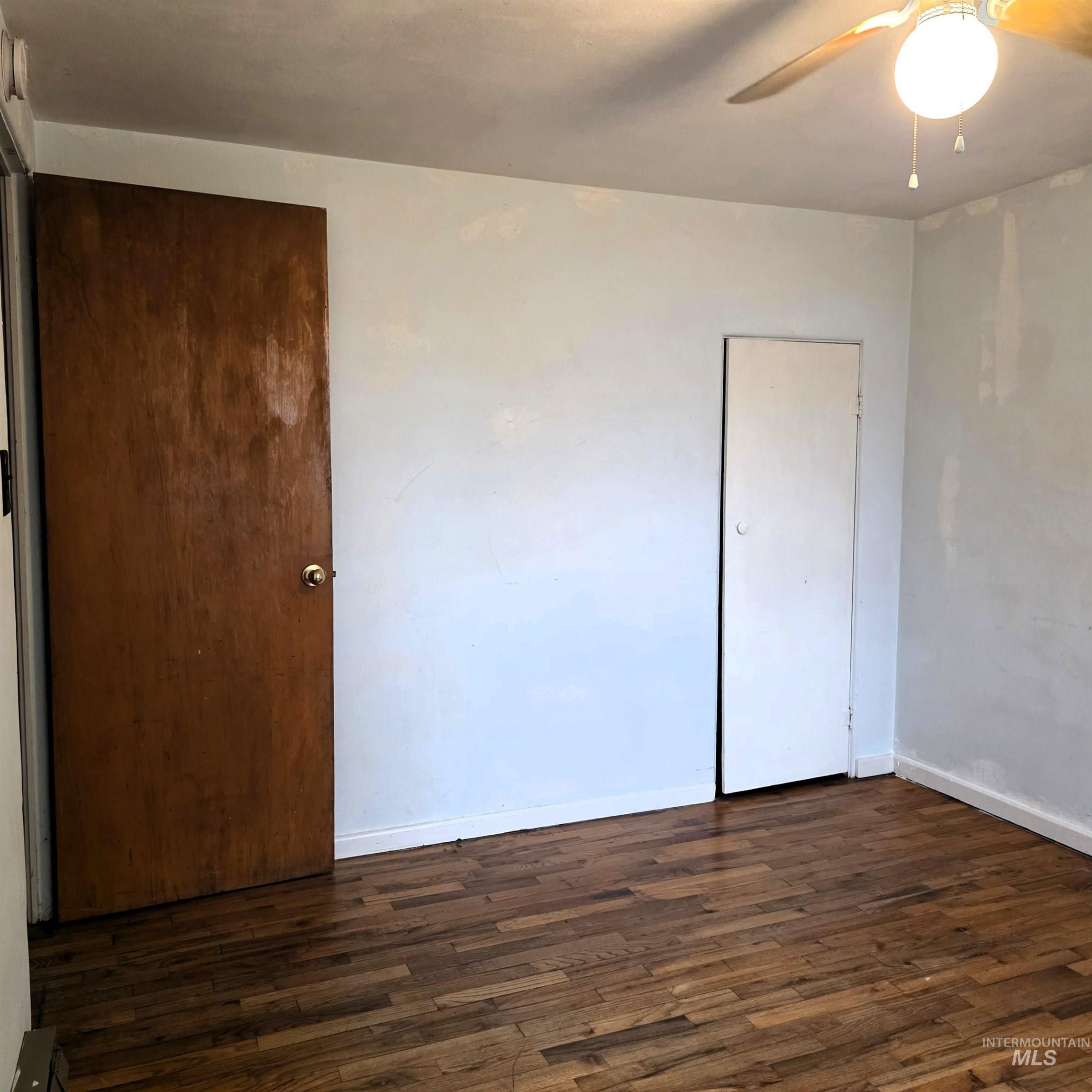 935 Preston Avenue Lewiston, ID 83501 - Photo 20 of 22 Unfurnished bedroom with dark wood-style floors and a ceiling fan