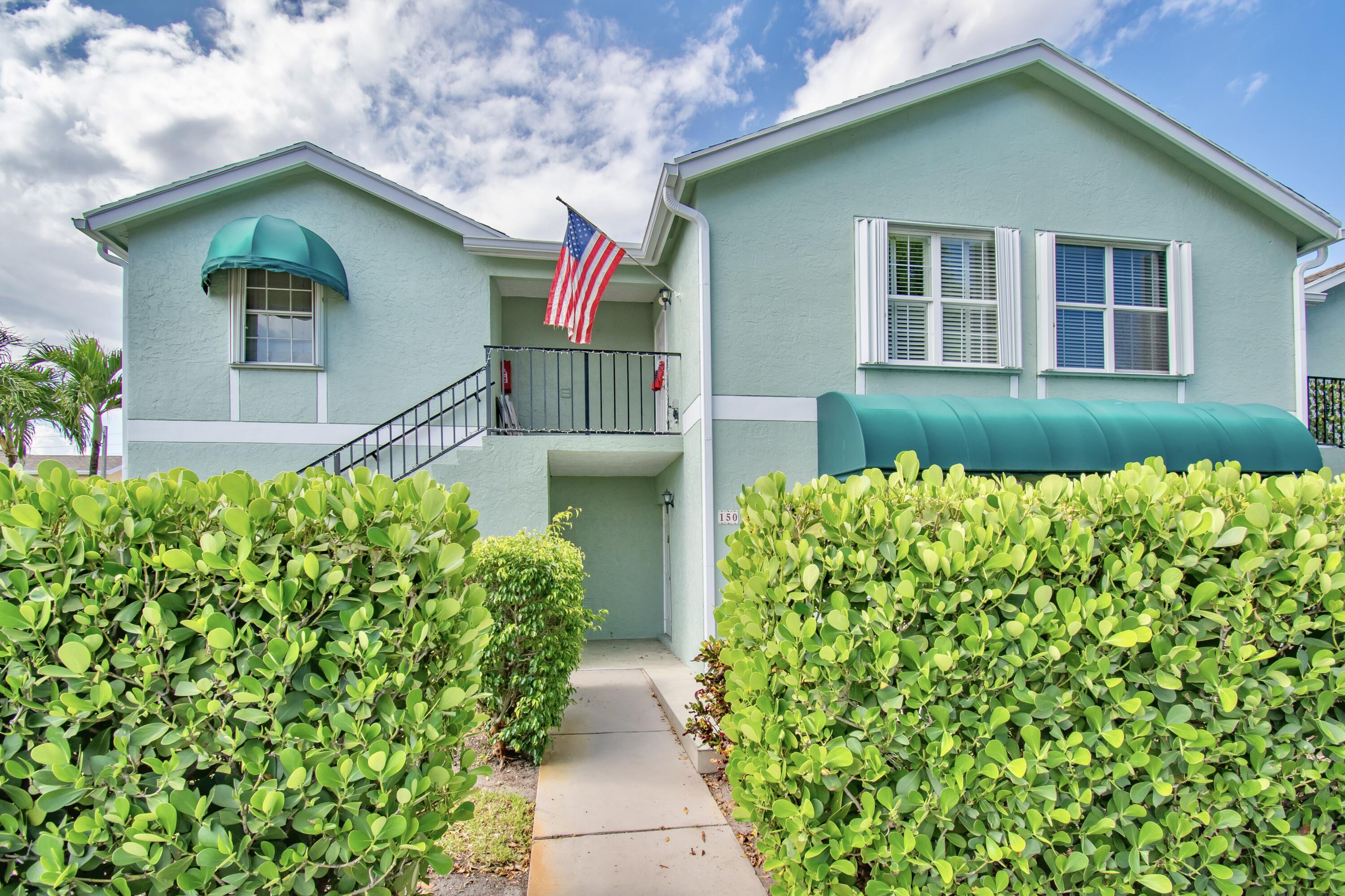 151 Waterside Drive Hypoluxo, FL 33462 - Photo 1 of 30 a front view of a house with a yard