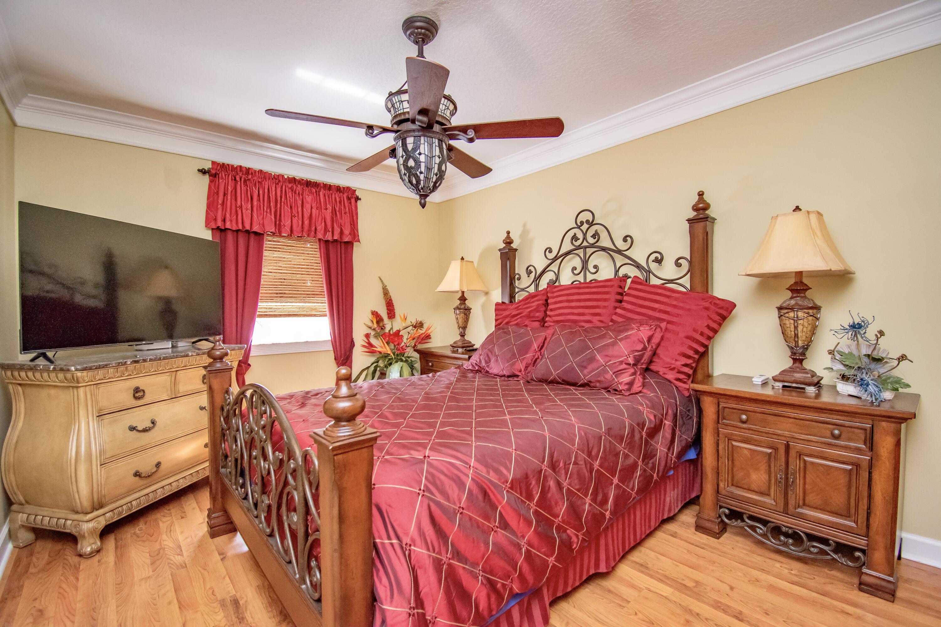 151 Waterside Drive Hypoluxo, FL 33462 - Photo 11 of 30 a bedroom with a bed and a flat screen tv