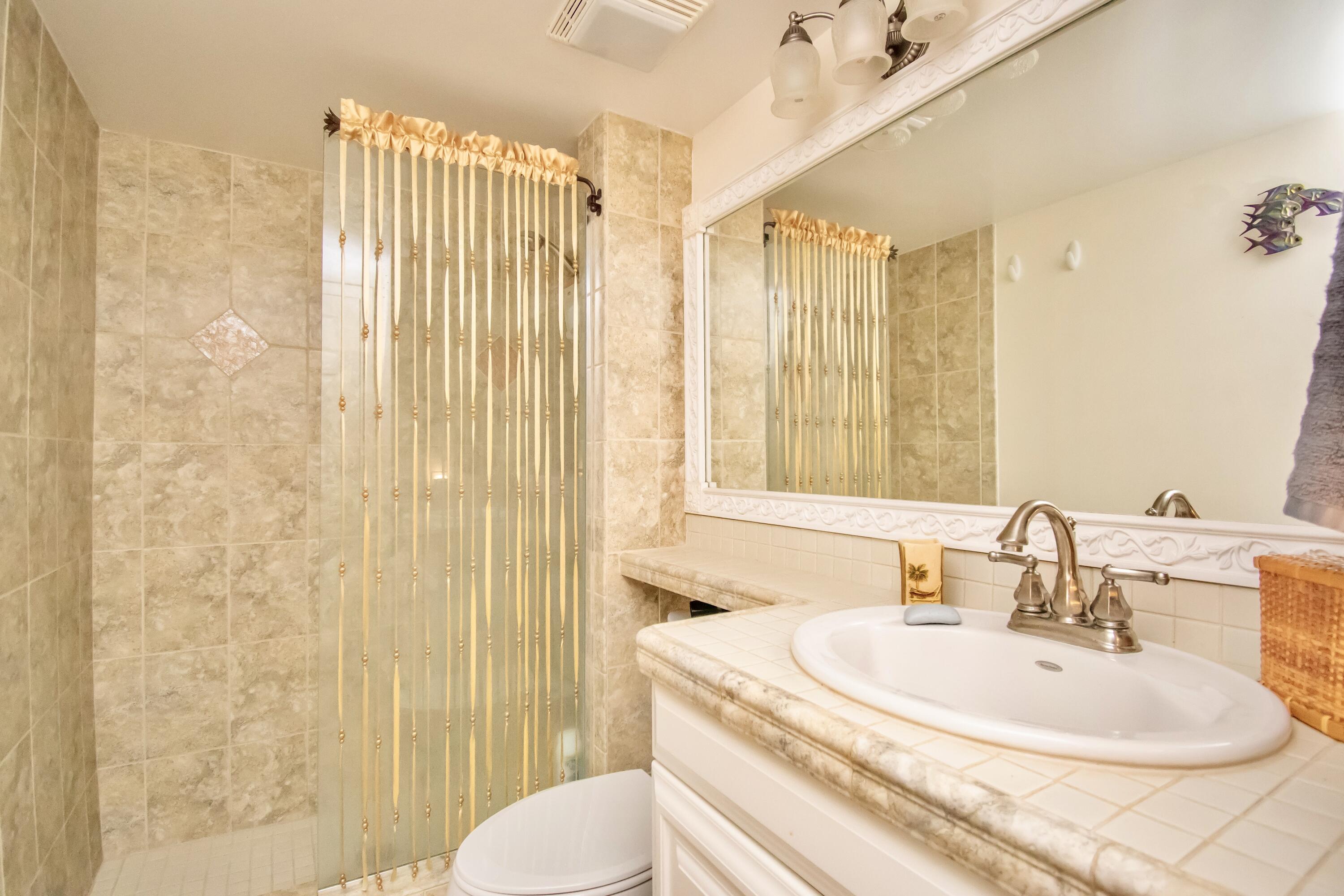 151 Waterside Drive Hypoluxo, FL 33462 - Photo 12 of 30 a bathroom with a sink toilet and shower