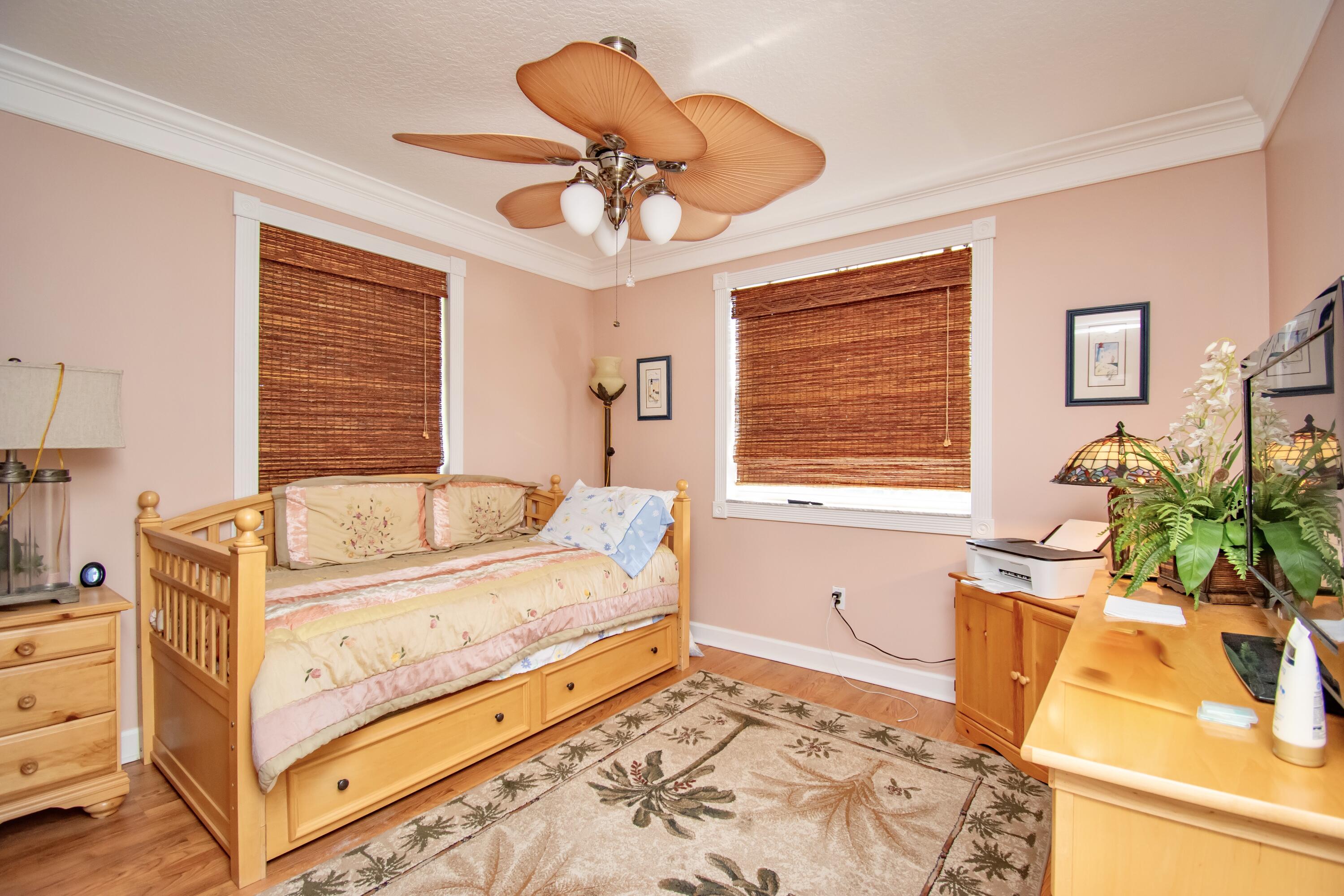 151 Waterside Drive Hypoluxo, FL 33462 - Photo 13 of 30 a bedroom with a bed and wooden floor