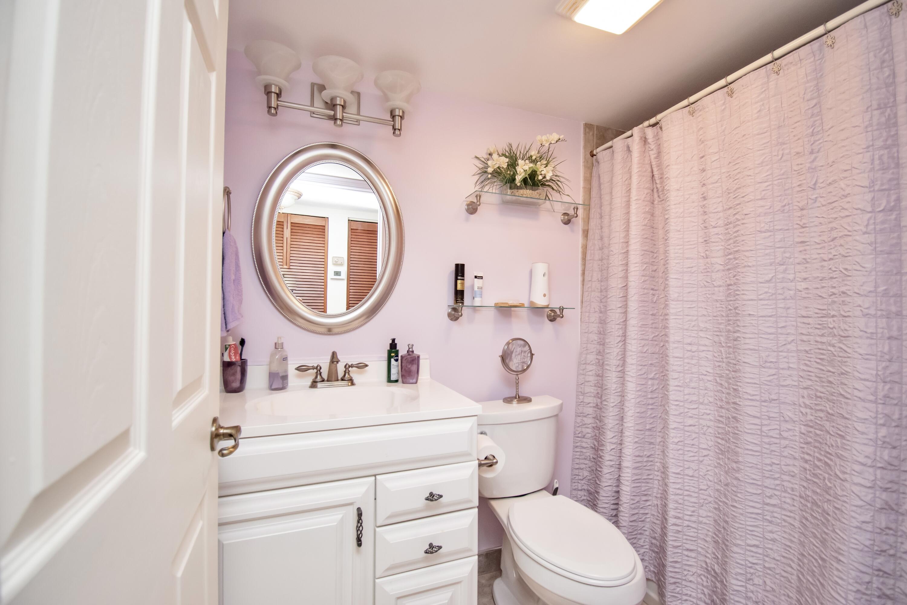 151 Waterside Drive Hypoluxo, FL 33462 - Photo 14 of 30 a bathroom with a sink mirror and toilet