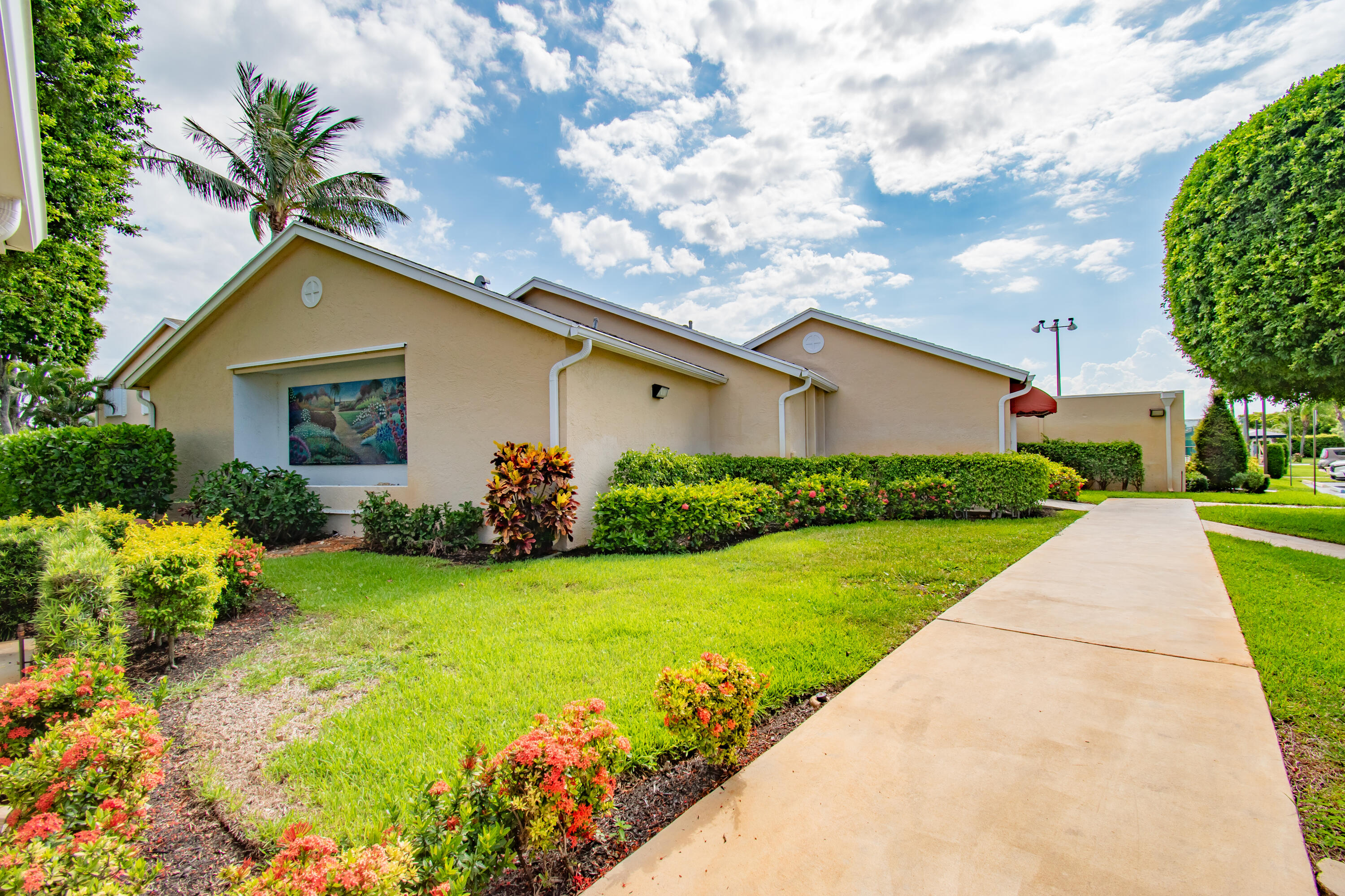 151 Waterside Drive Hypoluxo, FL 33462 - Photo 18 of 30 a house with garden in front of it