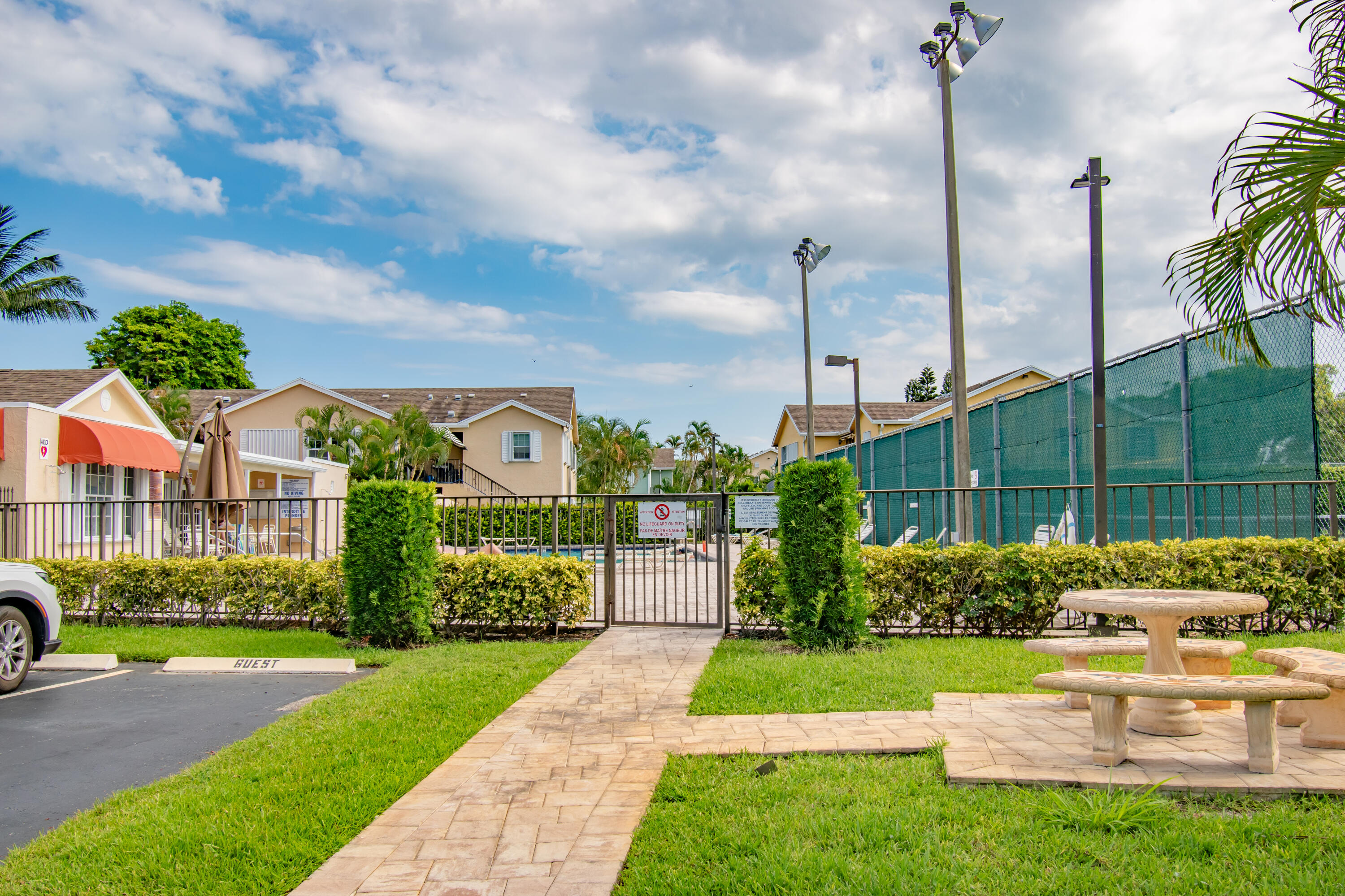 151 Waterside Drive Hypoluxo, FL 33462 - Photo 19 of 30 a front view of a house with a garden and plants