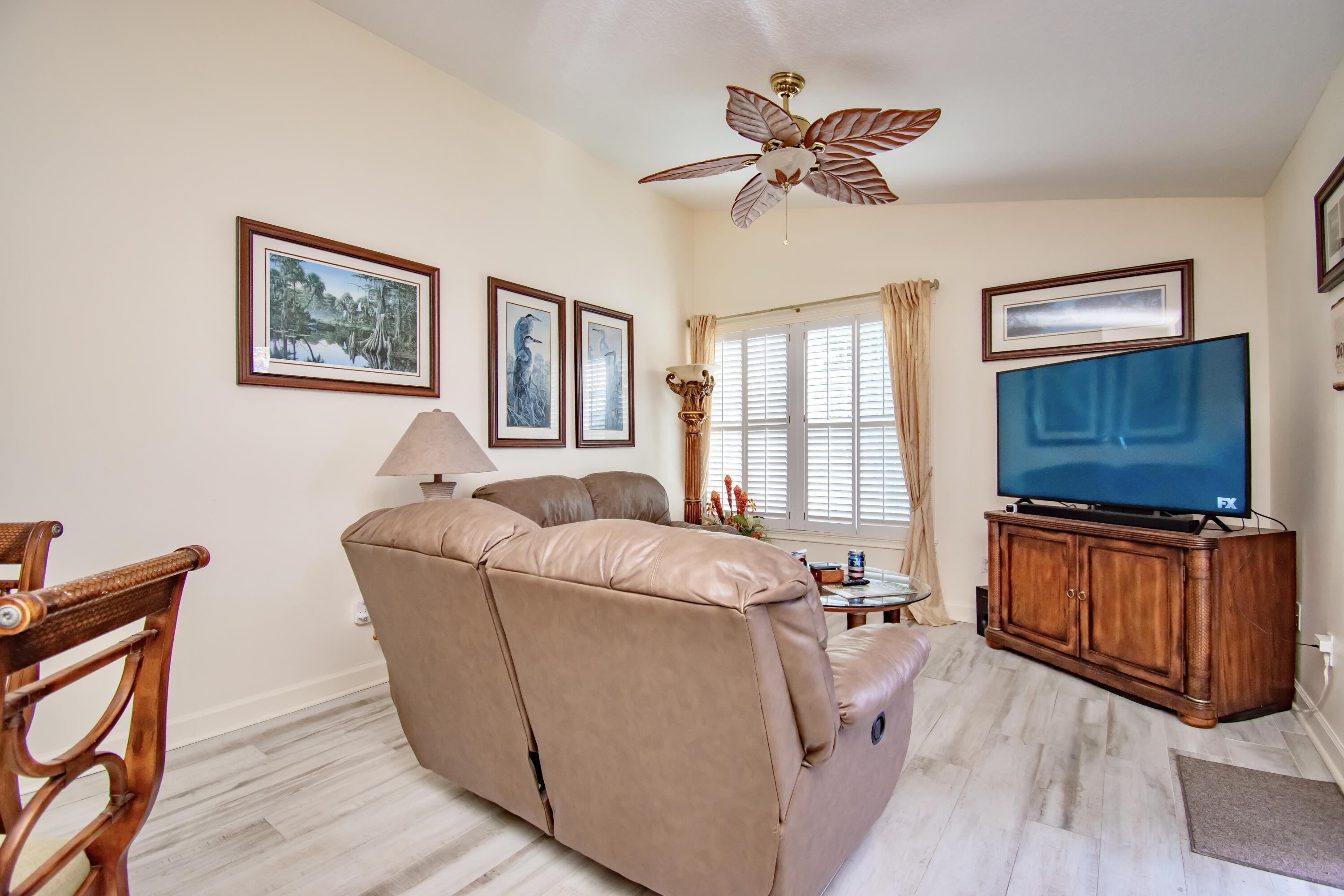 151 Waterside Drive Hypoluxo, FL 33462 - Photo 3 of 30 a living room with furniture and a flat screen tv