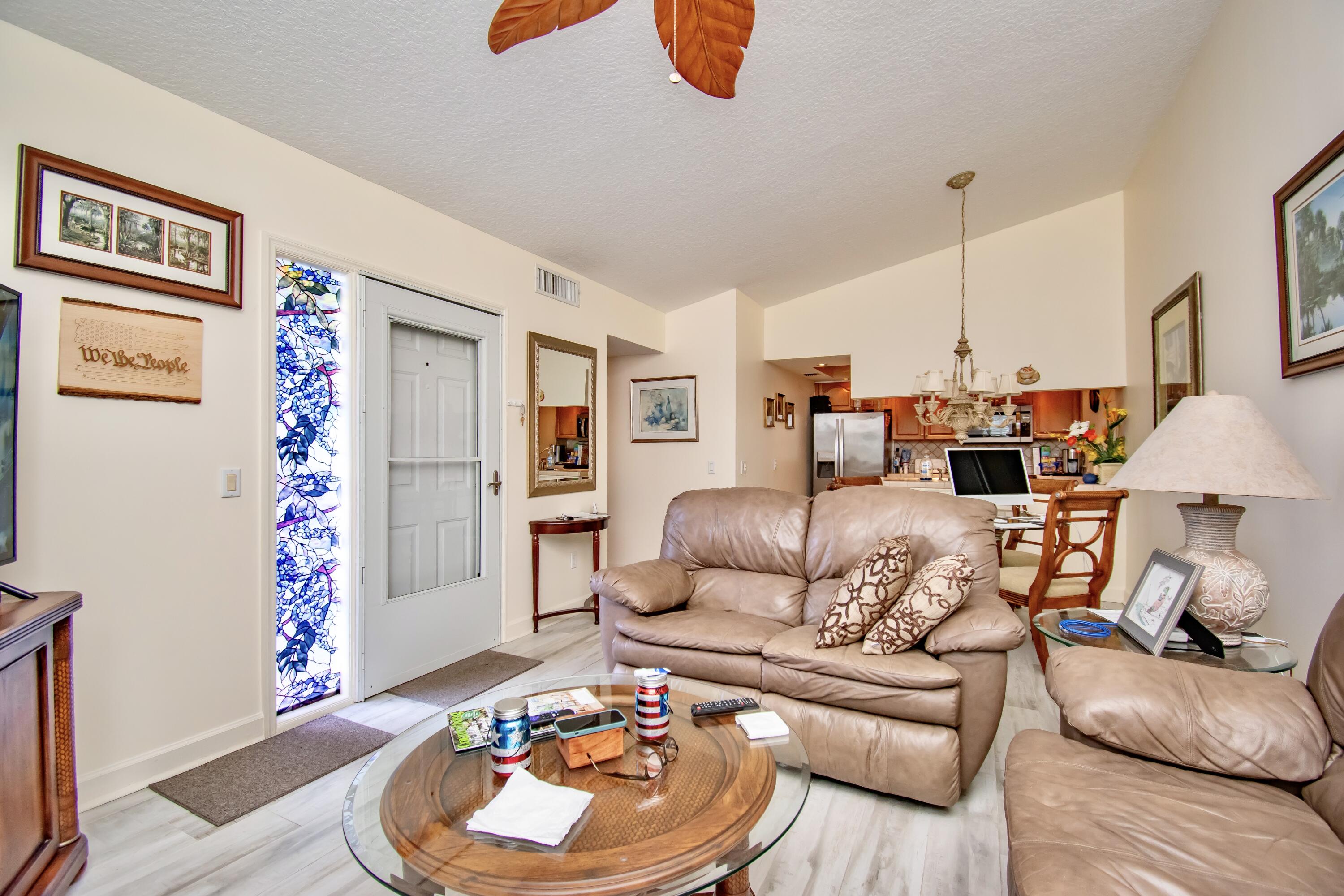 151 Waterside Drive Hypoluxo, FL 33462 - Photo 4 of 30 a living room with furniture and a wooden floor