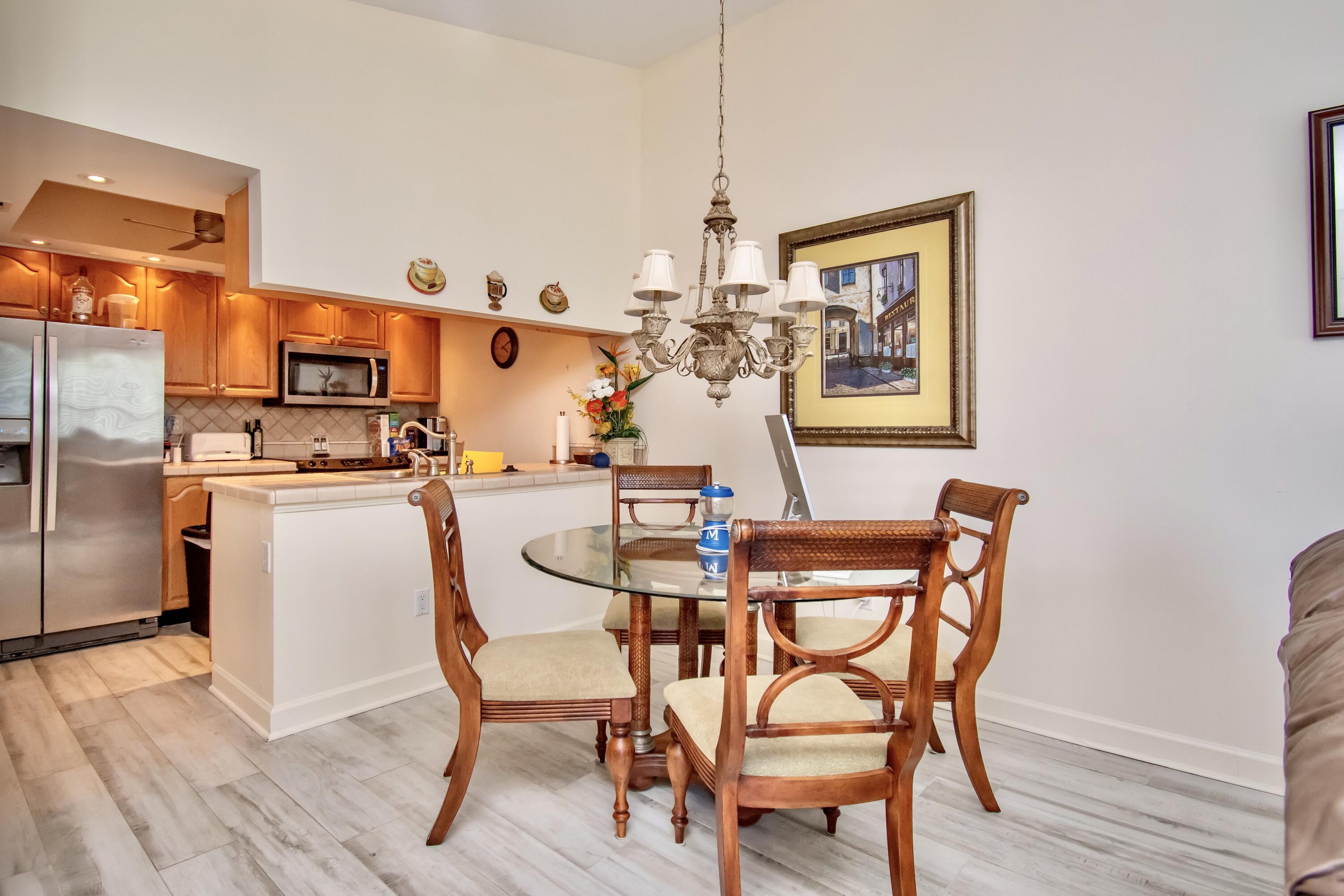151 Waterside Drive Hypoluxo, FL 33462 - Photo 5 of 30 a dining room with furniture and wooden floor