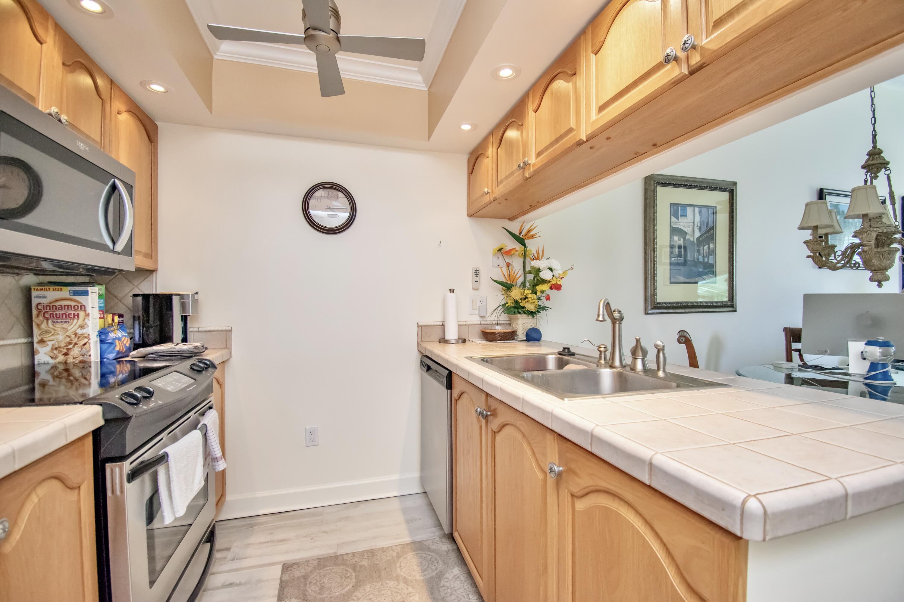151 Waterside Drive Hypoluxo, FL 33462 - Photo 9 of 30 a bathroom with a sink a vanity a mirror and a toilet