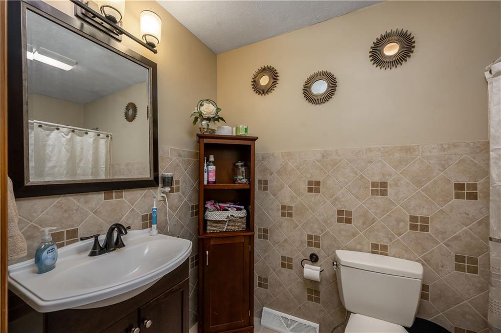 421 Protzman Road Butler, PA 16002 - Photo 13 of 30 a bathroom with a toilet sink and mirror