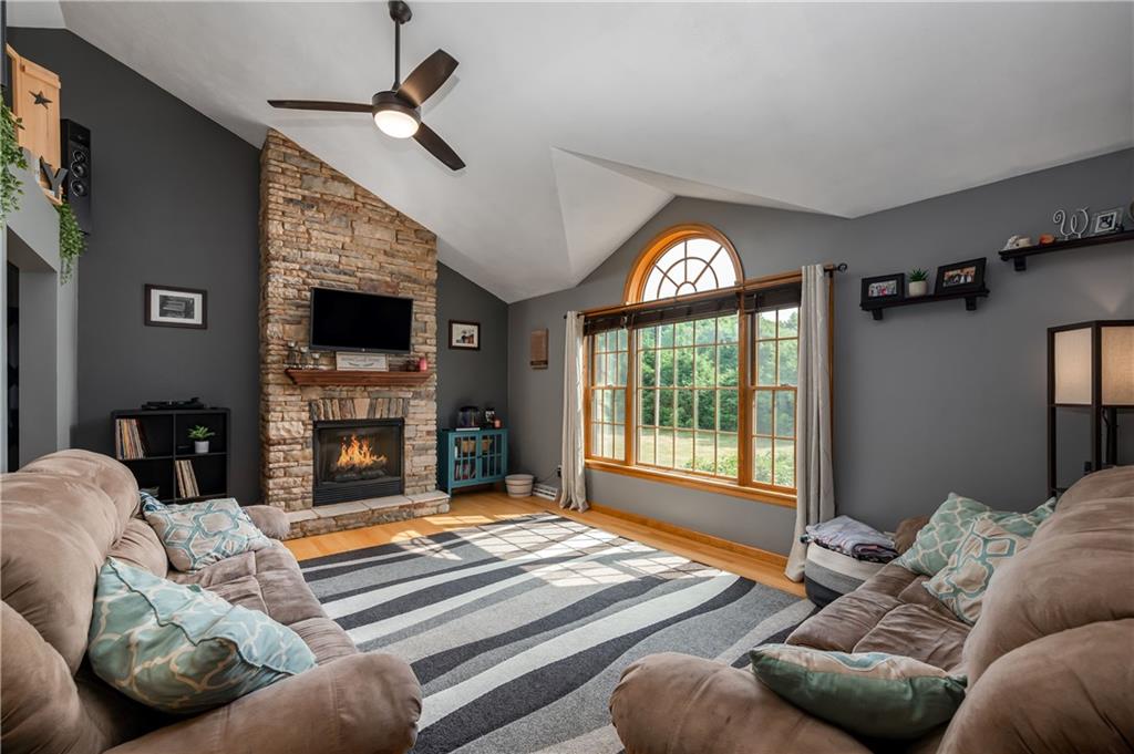 421 Protzman Road Butler, PA 16002 - Photo 4 of 30 a living room with furniture a fireplace and a flat screen tv
