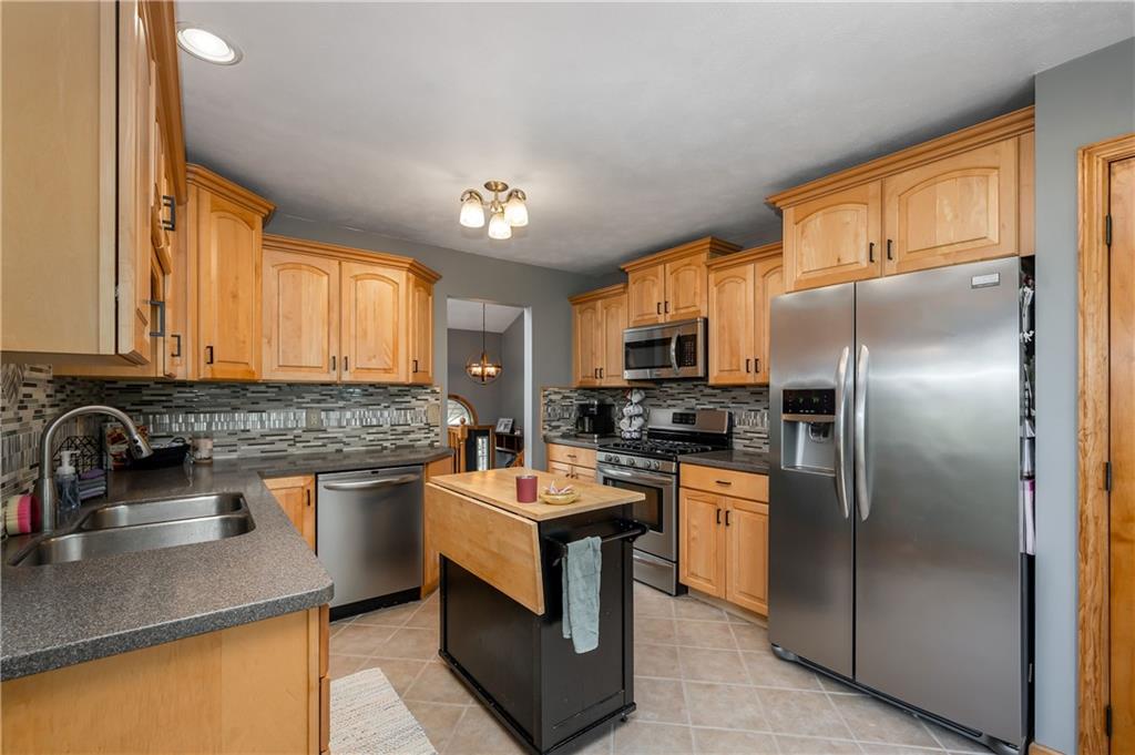 421 Protzman Road Butler, PA 16002 - Photo 9 of 30 a kitchen with stainless steel appliances granite countertop a sink stove and refrigerator
