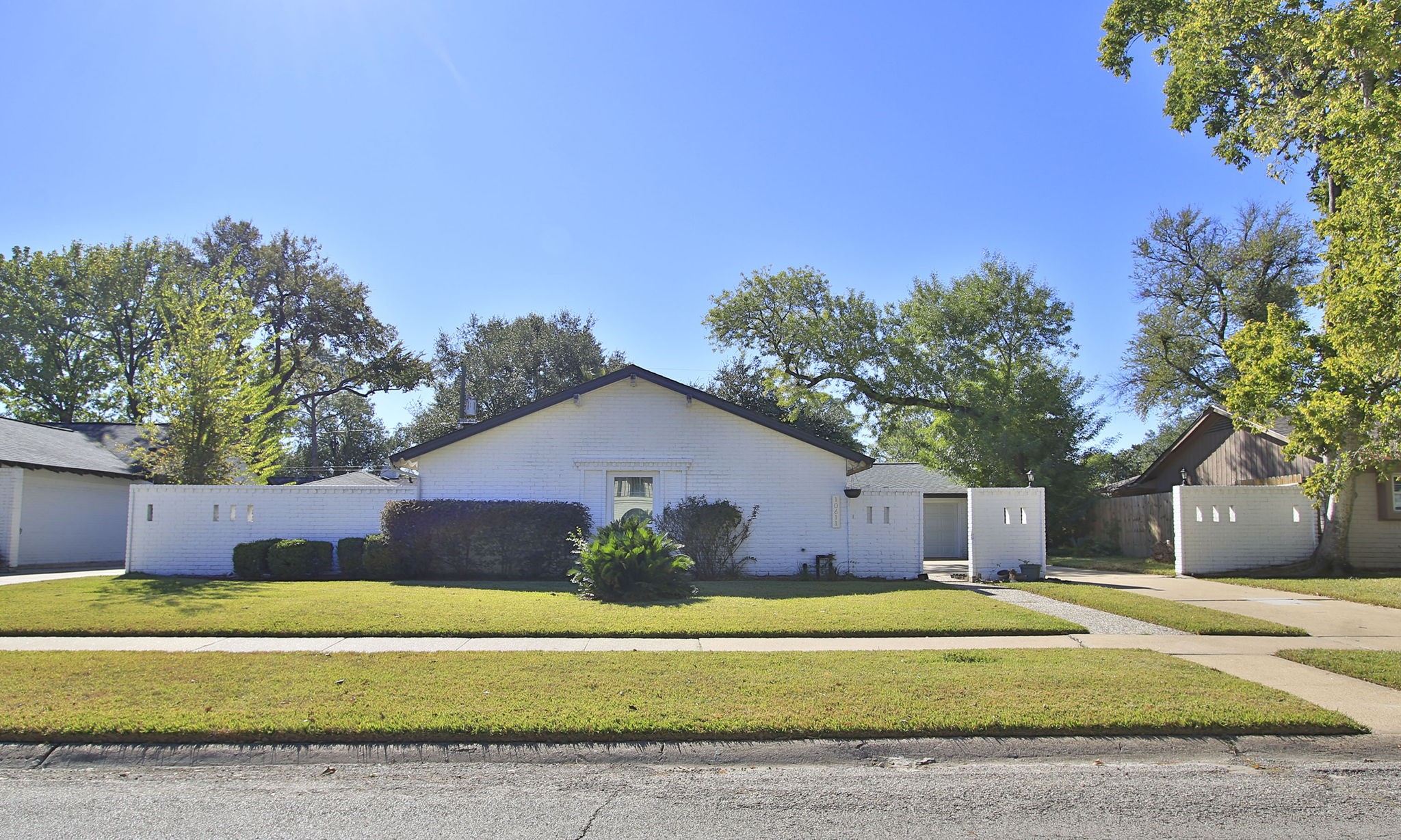 10611 Deerwood Road Houston, TX 77042 - Photo 1 of 47 a front view of a house with a yard and garage