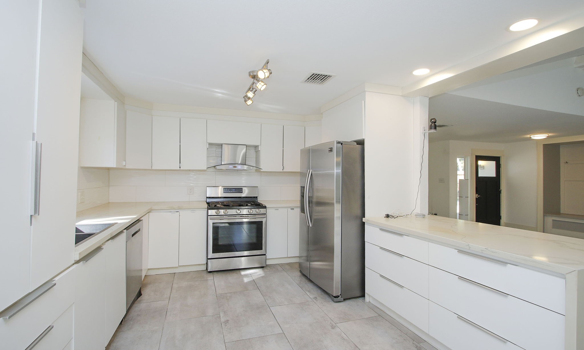 10611 Deerwood Road Houston, TX 77042 - Photo 16 of 47 a large kitchen with stainless steel appliances granite countertop a refrigerator and a stove top oven