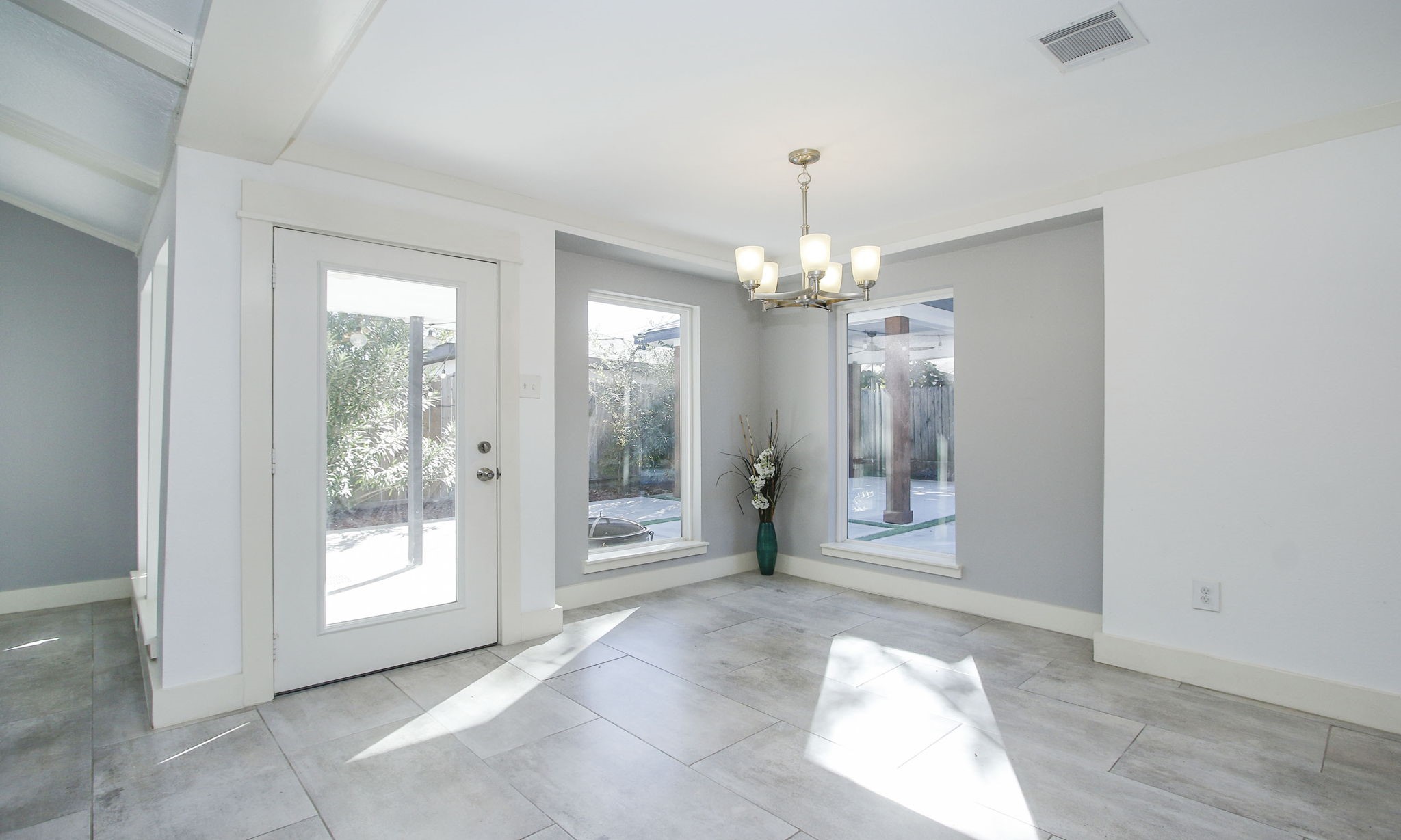 10611 Deerwood Road Houston, TX 77042 - Photo 19 of 47 a view of a big room with chandelier mirror and windows