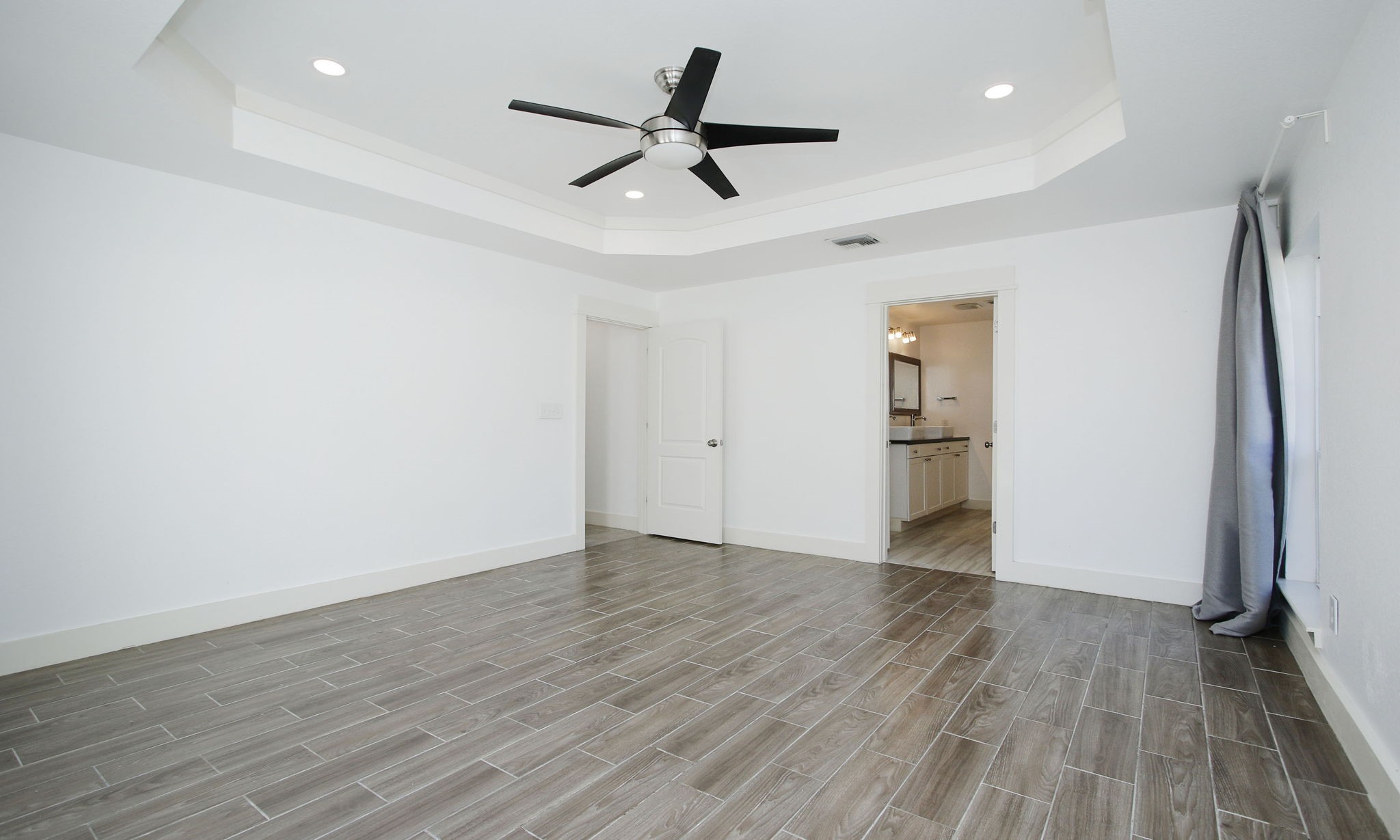10611 Deerwood Road Houston, TX 77042 - Photo 22 of 47 a view of empty room with wooden floor and window