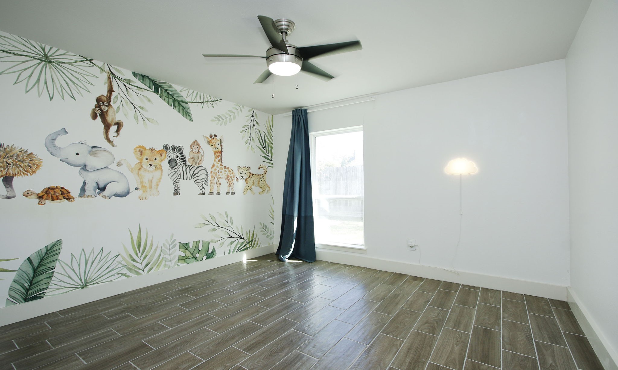 10611 Deerwood Road Houston, TX 77042 - Photo 31 of 47 an empty room with a window and ceiling fan