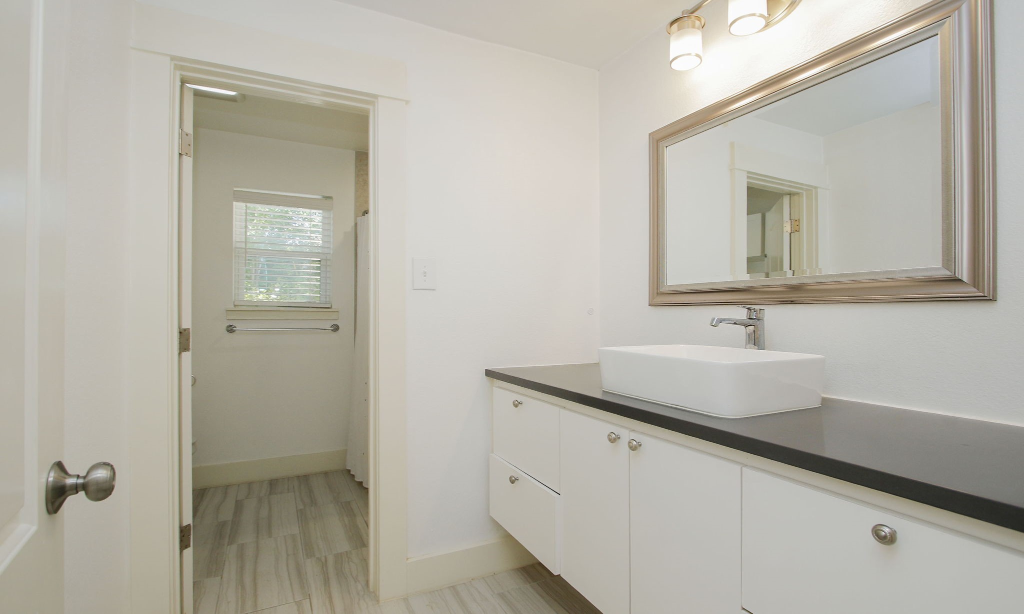 10611 Deerwood Road Houston, TX 77042 - Photo 33 of 47 a bathroom with a sink and a mirror