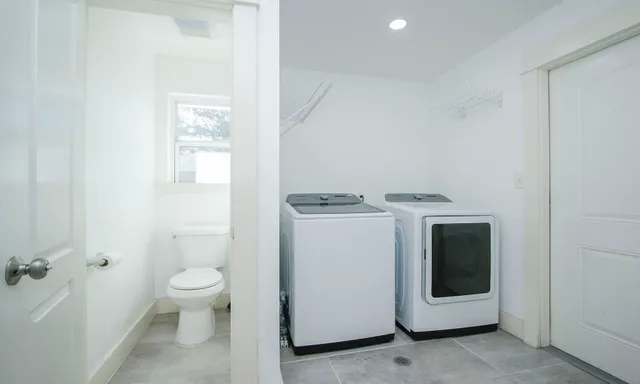 a patio with glass top table and chairs