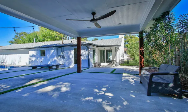 a view of outdoor space with pool and wooden fence