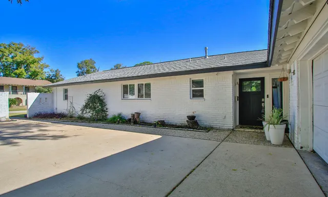 front view of house with potted plants