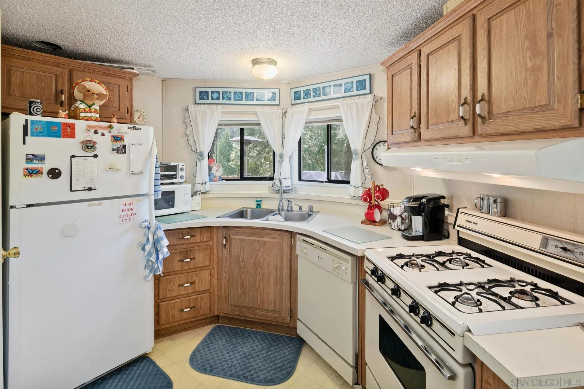 5820 Boulder Creek Road Julian, CA 92036 - Photo 50 of 75 a kitchen with a stove a sink and a refrigerator