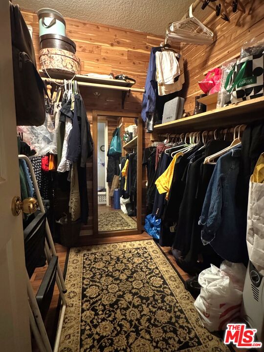 19928 Chase Street, Unit 27 Winnetka, CA 91306 - Photo 11 of 18 a view of walk in closet with clothes and shoes