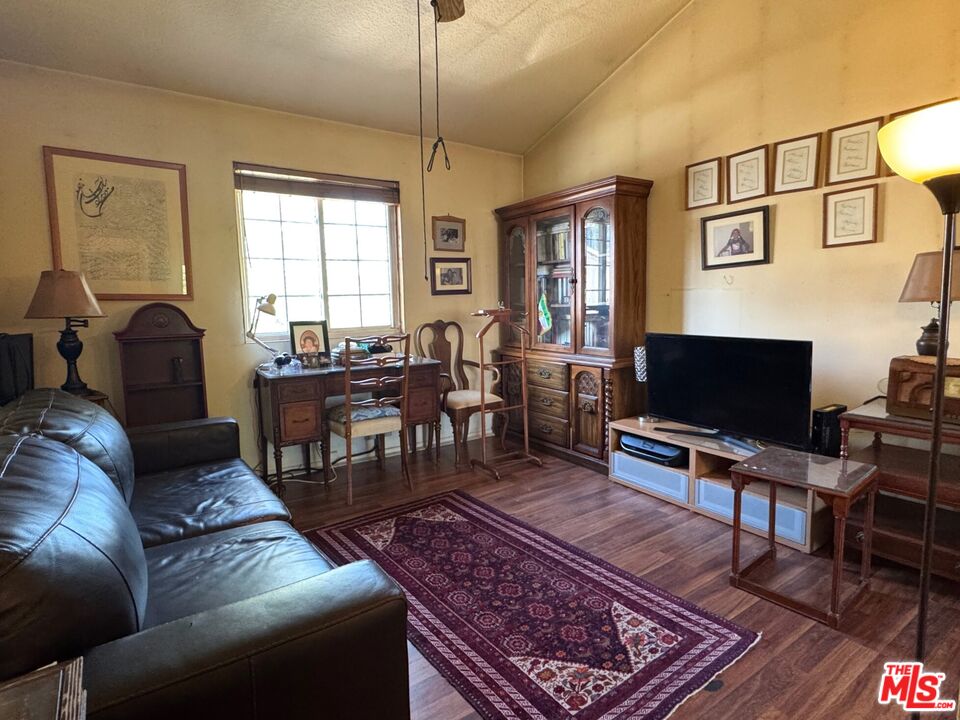 19928 Chase Street, Unit 27 Winnetka, CA 91306 - Photo 12 of 18 a living room with furniture a piano and a flat screen tv
