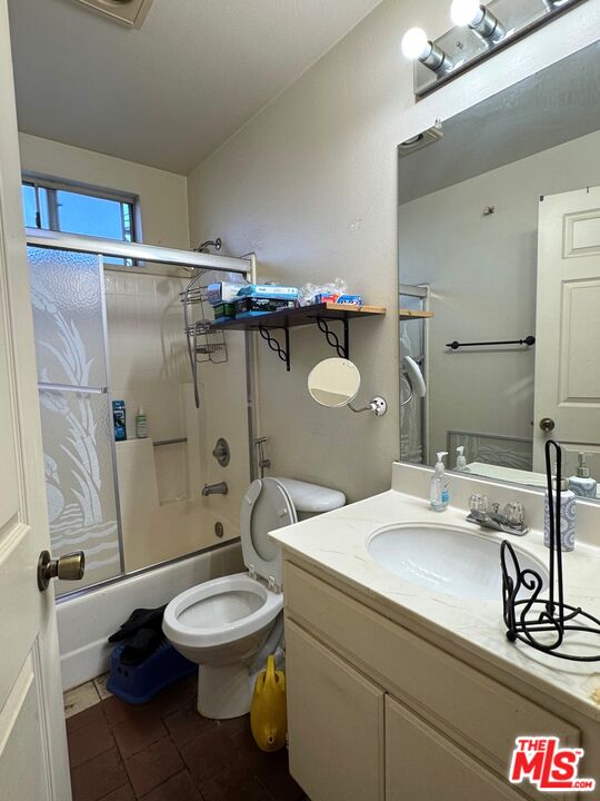 19928 Chase Street, Unit 27 Winnetka, CA 91306 - Photo 13 of 18 a bathroom with a sink a toilet and shower
