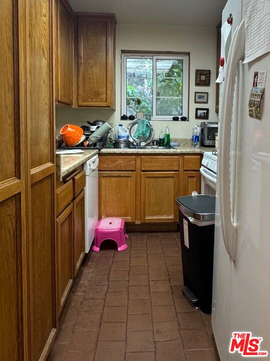19928 Chase Street, Unit 27 Winnetka, CA 91306 - Photo 5 of 18 a kitchen with stainless steel appliances a stove window and cabinets