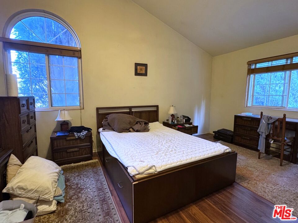 19928 Chase Street, Unit 27 Winnetka, CA 91306 - Photo 9 of 18 a bedroom with a bed and wooden floor
