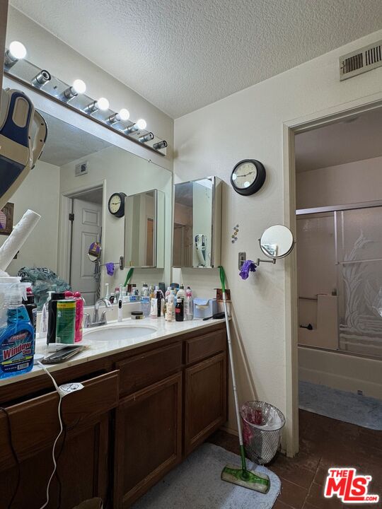 19928 Chase Street, Unit 27 Winnetka, CA 91306 - Photo 10 of 18 a bathroom with a sink a mirror and a shower