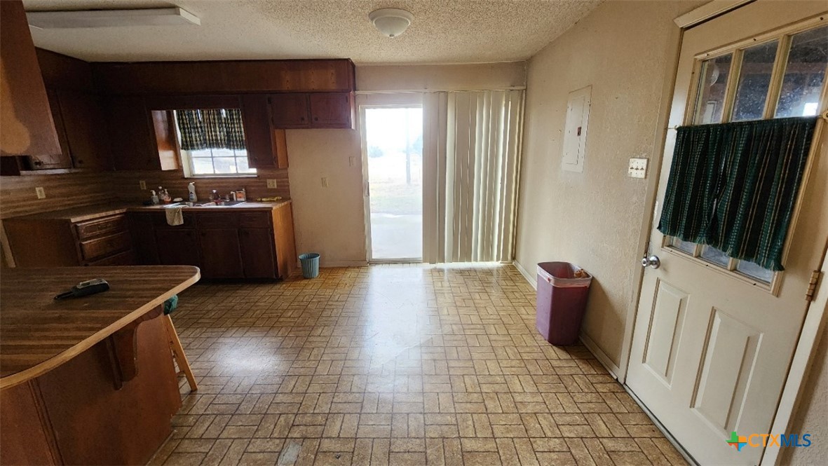 2002 Airville Road Temple, TX 76501 - Photo 14 of 41 a kitchen with a refrigerator and wooden cabinets